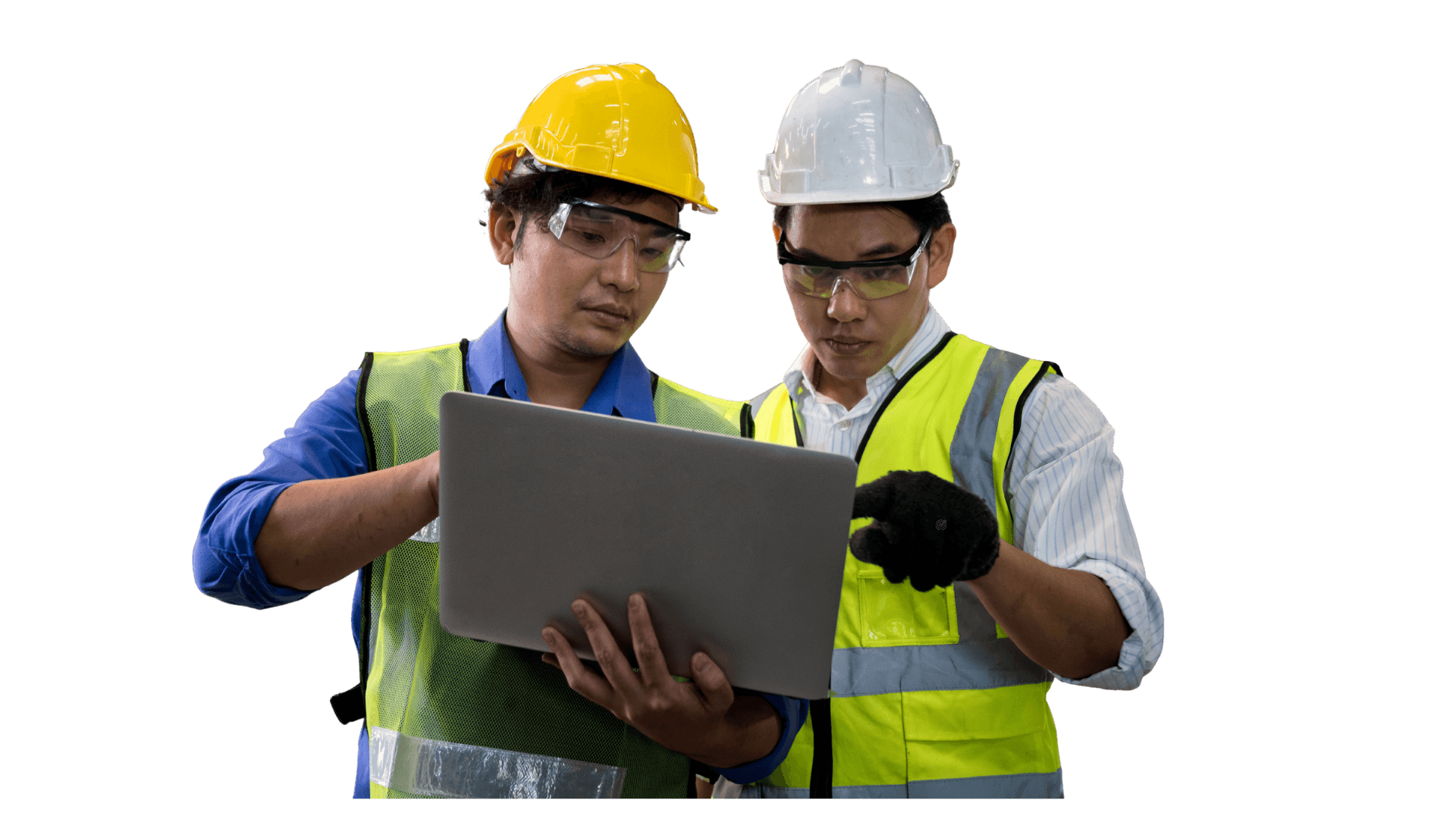 Two engineers wearing hard hats, safety goggles, and high-visibility vests looking at a laptop screen together.